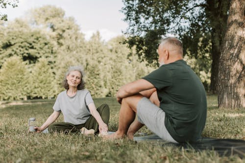 An Elderly Couple Sitting at the Park while Having Conversation