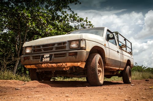 White and Gray Vehicle on a Dirt Road