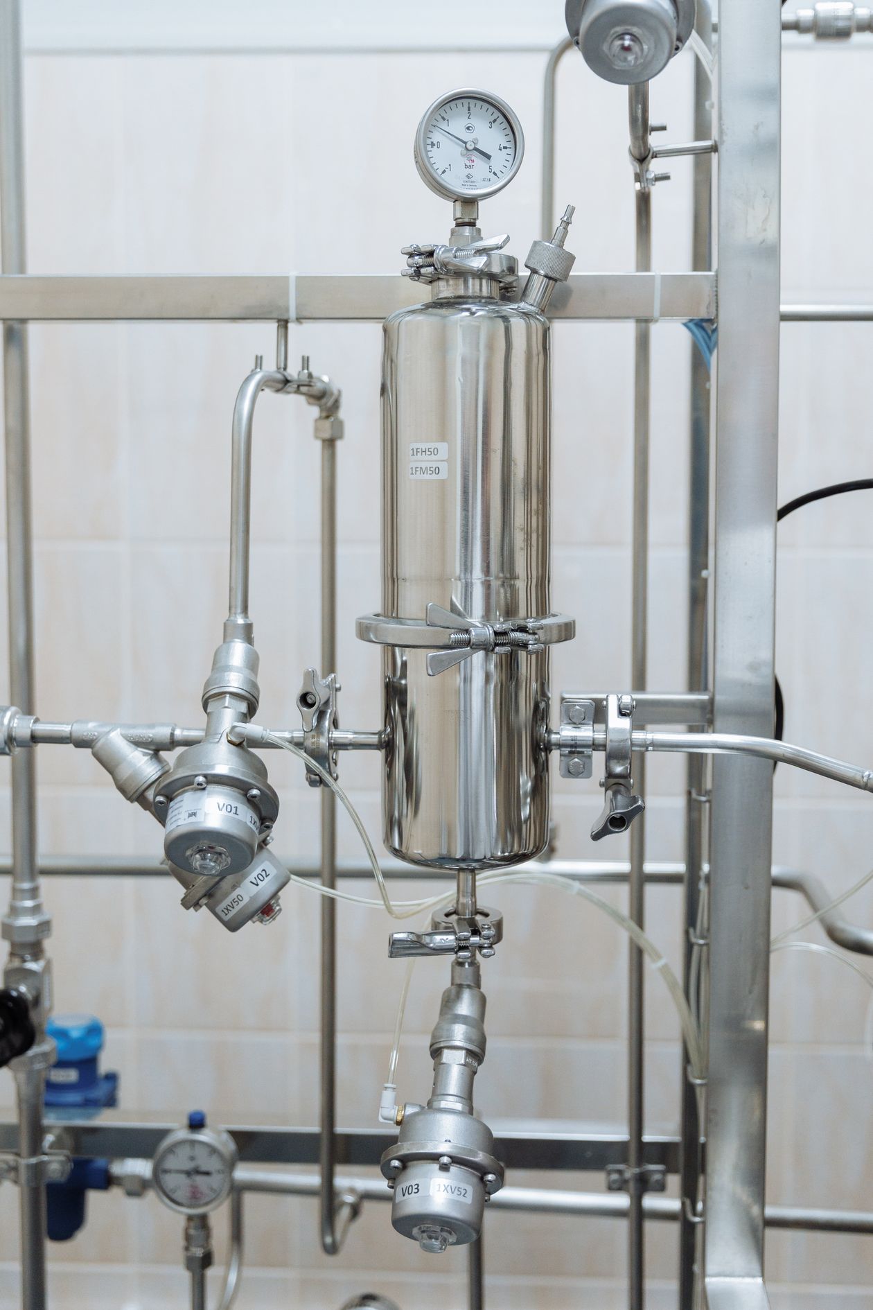 Stainless steel industrial pipe with pressure gauge and multiple valve connections