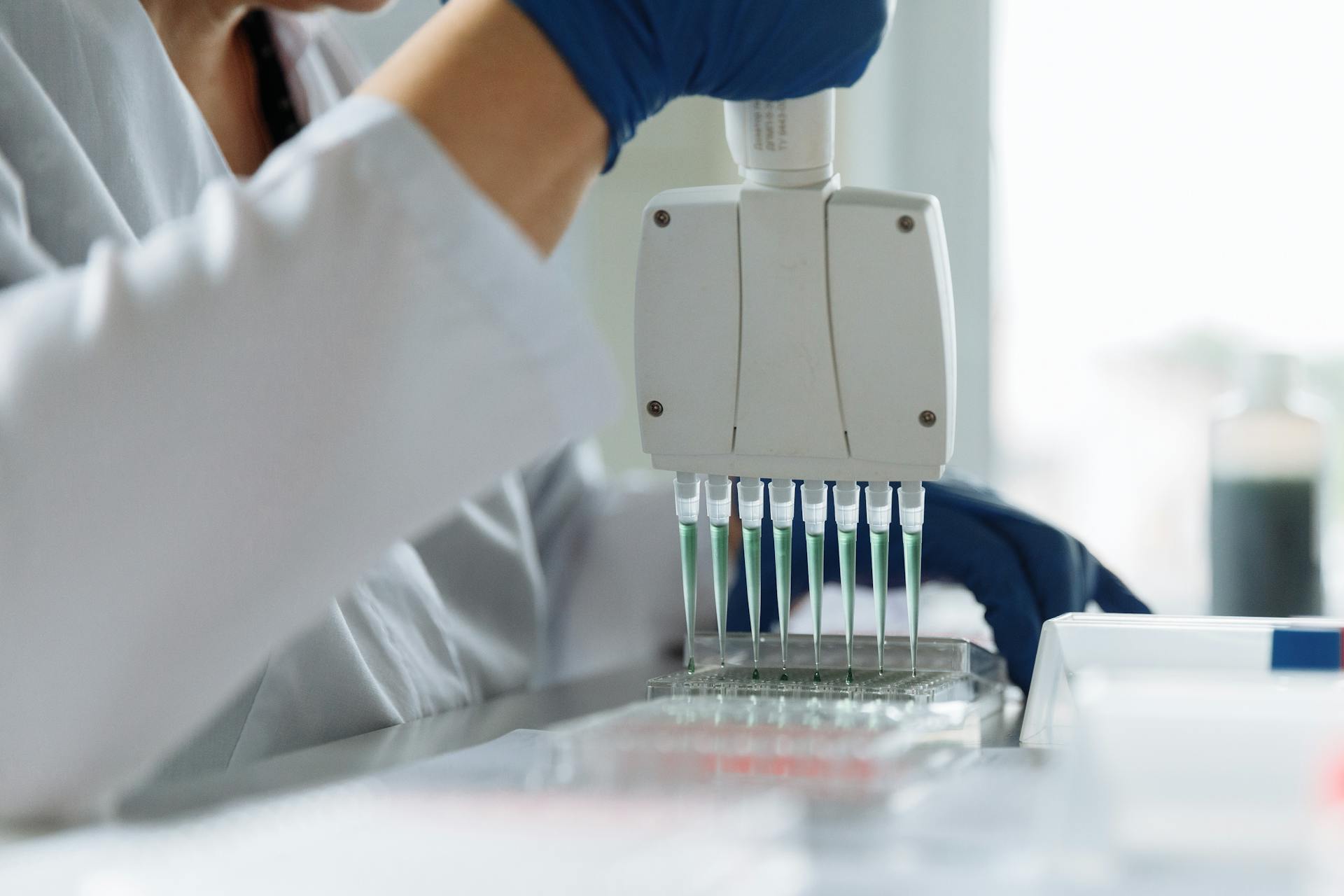 Scientist Holding a Pipette