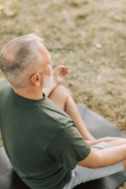 Free An Elderly Man Sitting while Meditating Stock Photo
