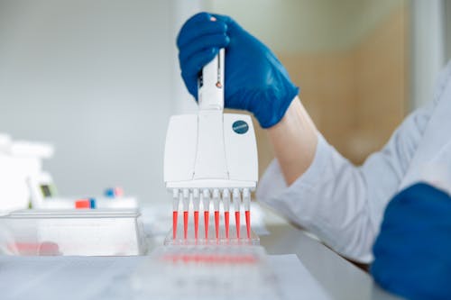 Close-up of a Lab Worker Distributing Medication into Capsules 