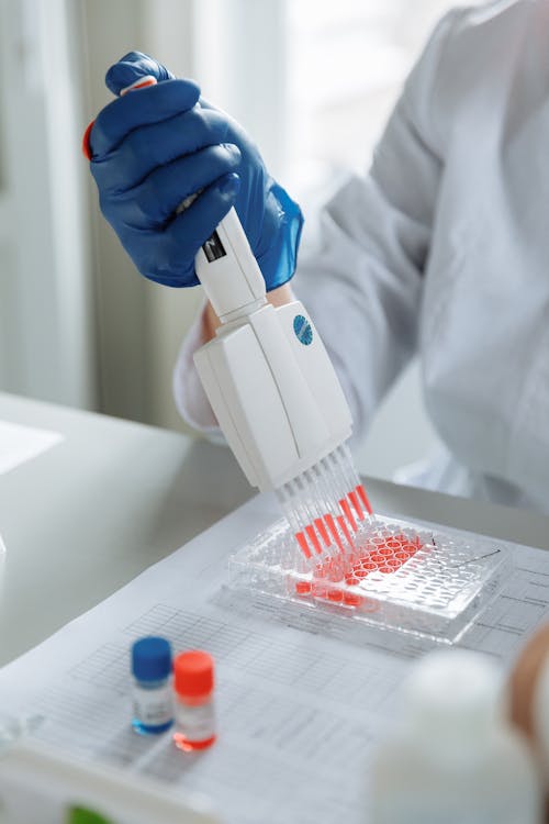 A Scientist Using a Laboratory Equipment