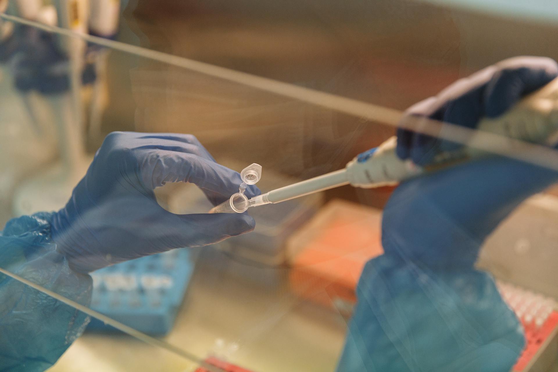 Close-up of a Laboratory Worker Using a Pipette and a Test Tube