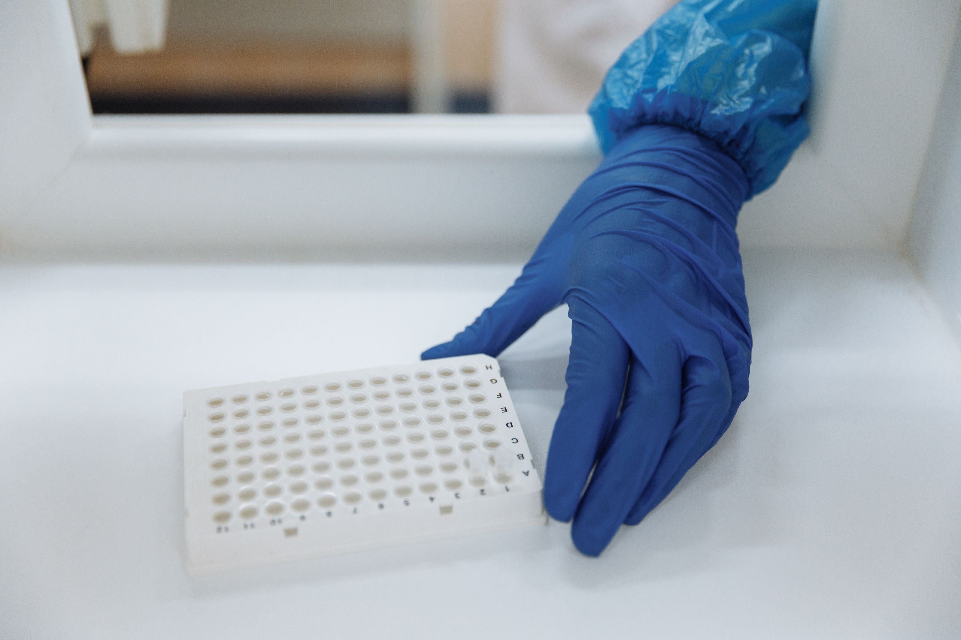 Scientist examining peptide vials under laboratory lighting