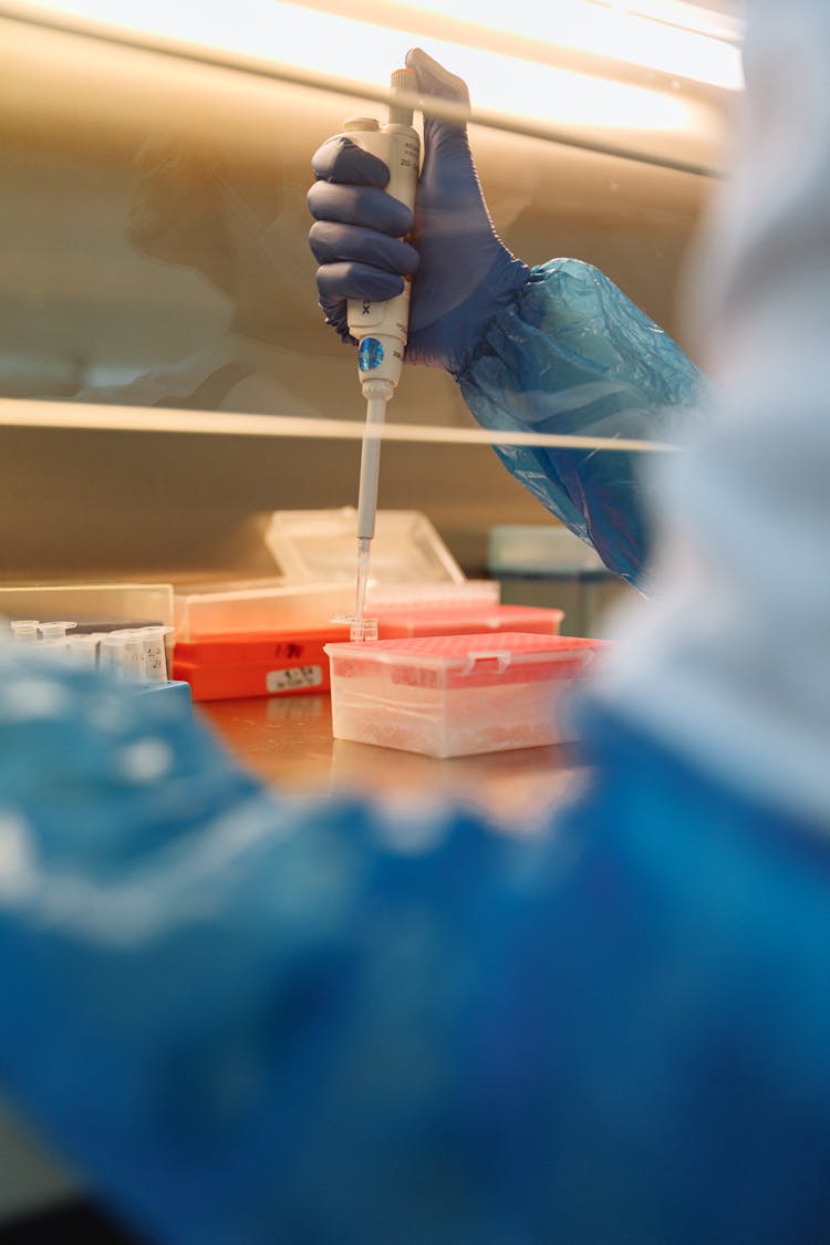 A Scientist Holding A Dropper