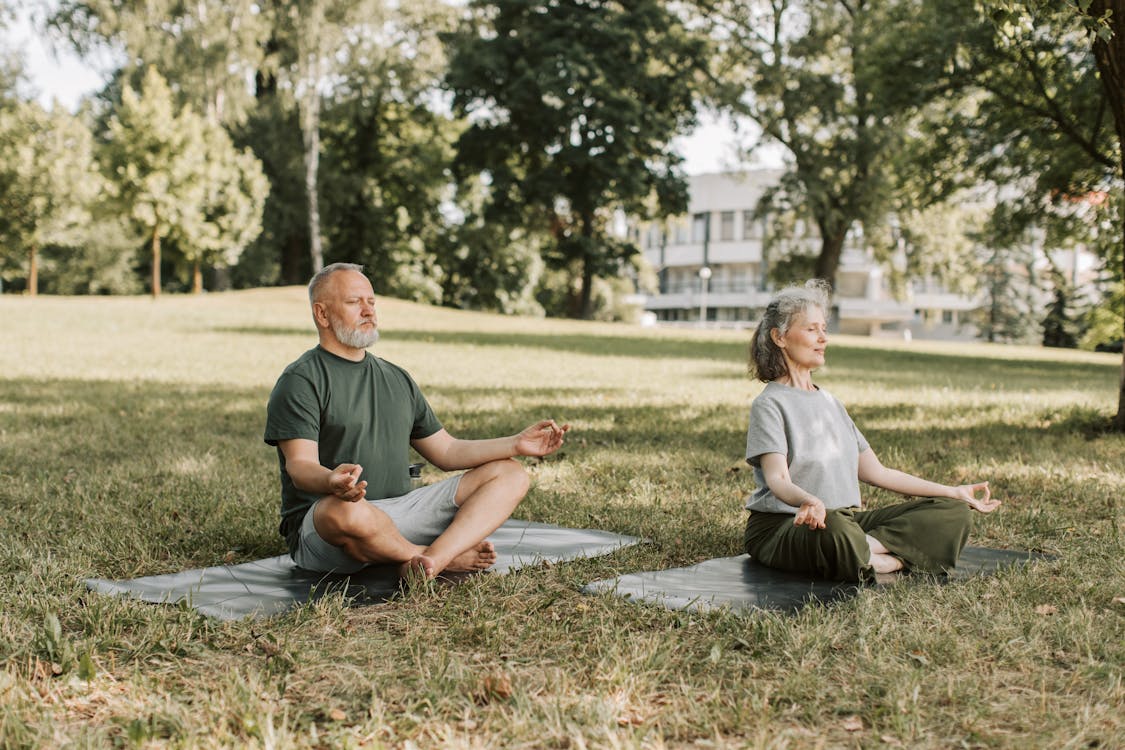 Free An Elderly Couple Meditating at the Park Stock Photo