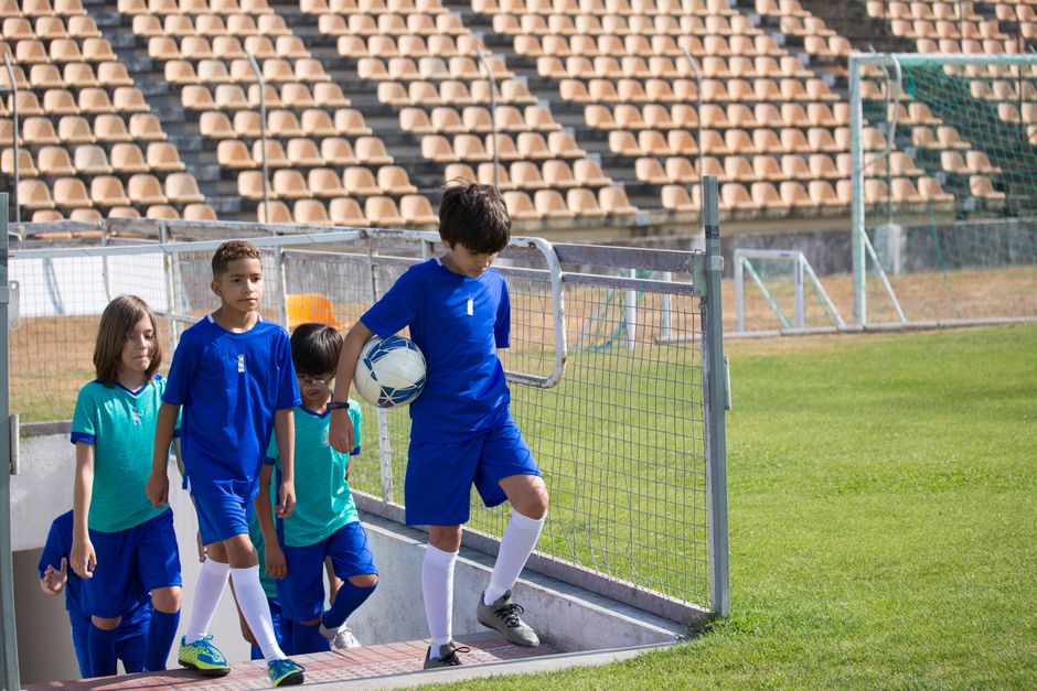 soccer players entering stadium