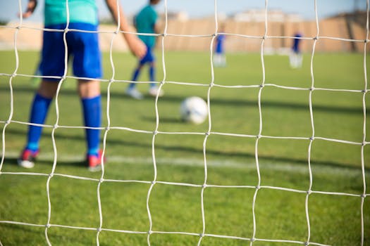 Capturing a youth soccer match with players in blue jerseys on a sunny day in Portugal.