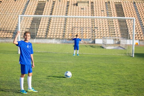 Boy in Blue Jersey Playing Soccer