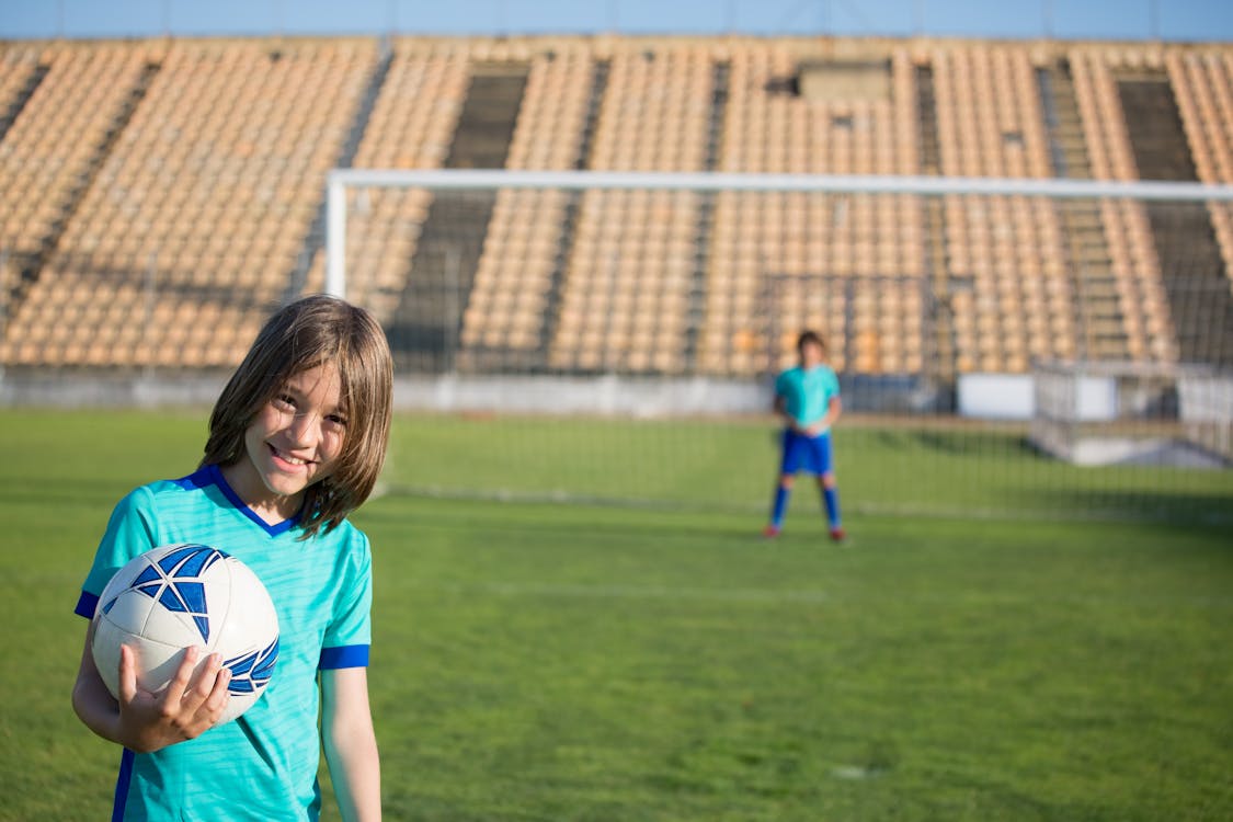Free Kid Holding the Soccer Ball Stock Photo