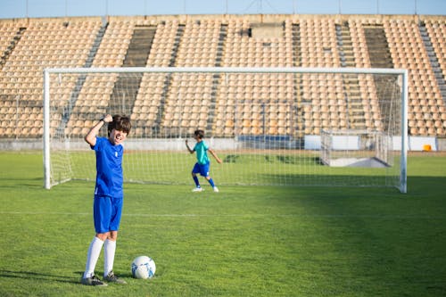 Children Playing Soccer on Field