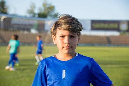 A Young Boy at the Football Field
