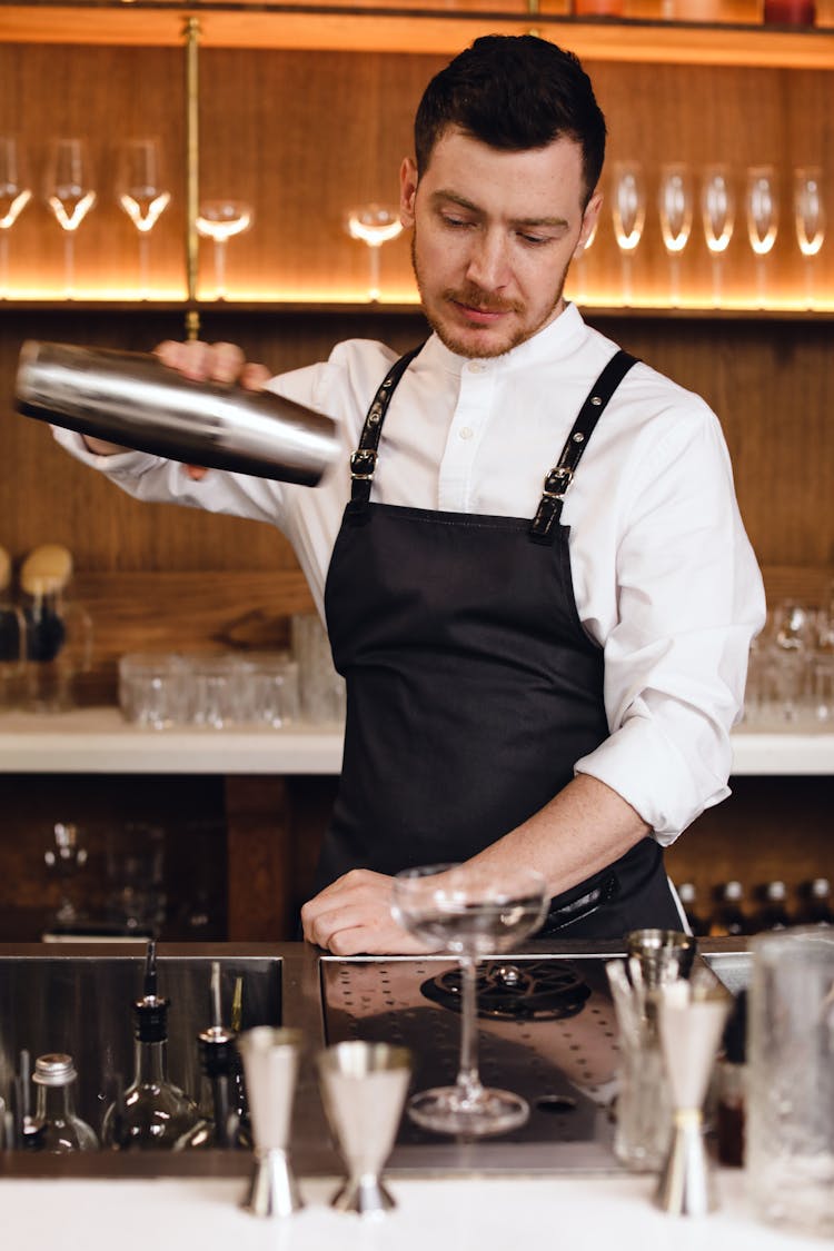 A Man Holding A Cocktail Shaker