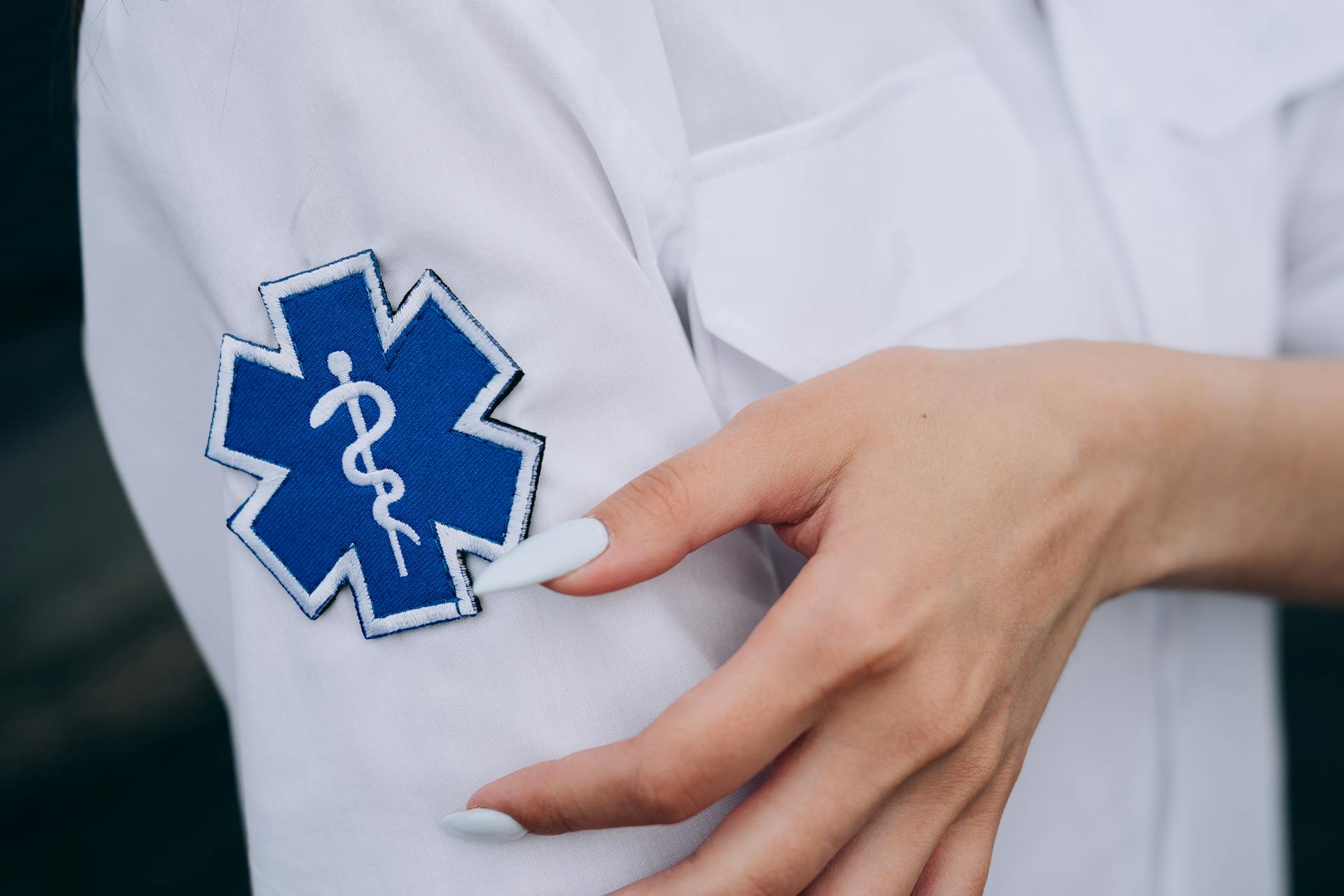 Close-up of a Badge in the Shirt of a Paramedic