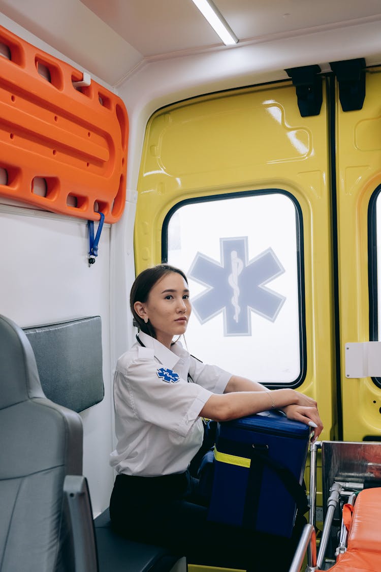 A Paramedic Sitting Inside An Ambulance