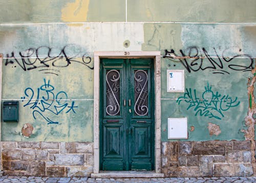 Free A Wooden Antique Door of a Building Stock Photo