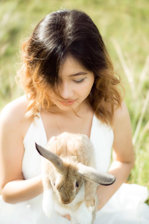 Close-Up Photo of a Woman Holding a Cute Bunny