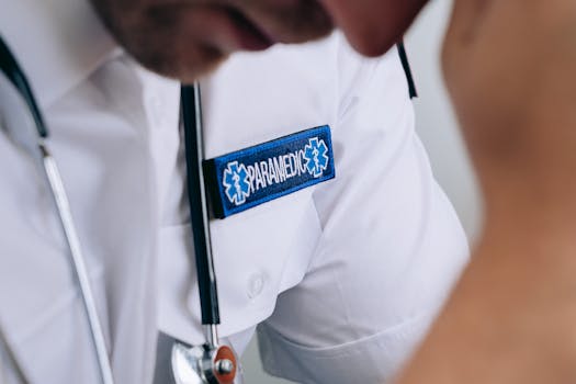 Detailed shot of a paramedic in uniform, highlighting the badge and stethoscope.
