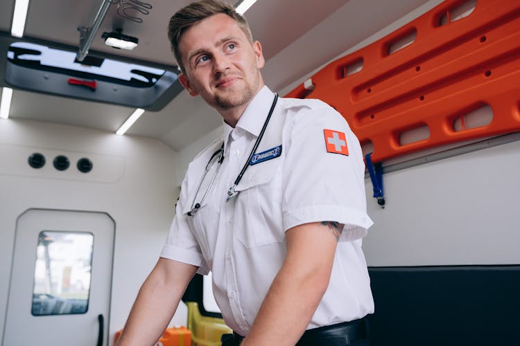 A Paramedic Smiling Inside An Ambulance