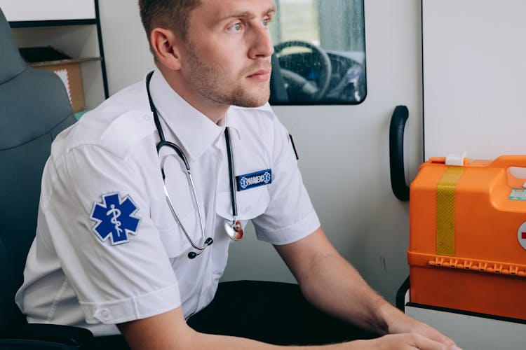 Man Sitting Inside An Ambulance