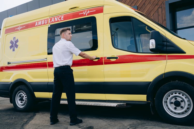 A Paramedic Opening An Ambulance Door