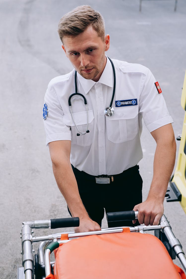 A Paramedic Holding Onto A Stretcher