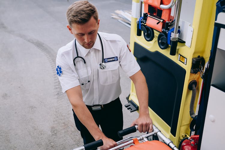 A Paramedic Grabbing A Stretcher From An Ambulance