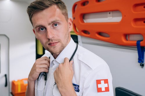 Free A Male Paramedic Inside an Ambulance Stock Photo