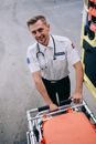 A Paramedic Pulling Out the Ambulance Bed