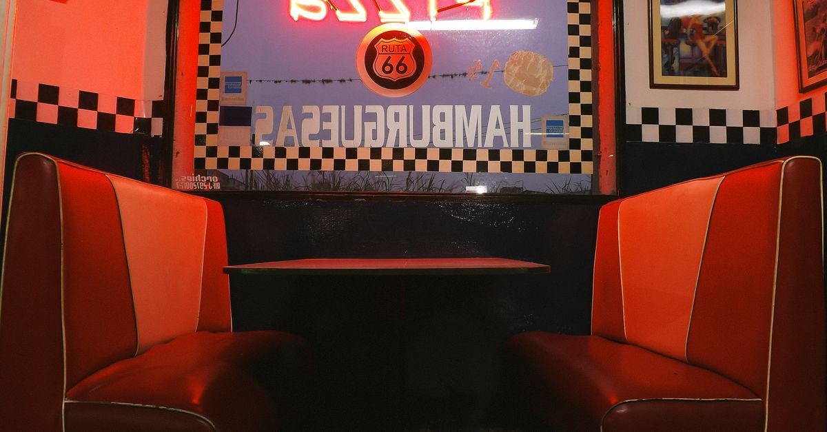 cozy 24 hour diner with people at booths late at night