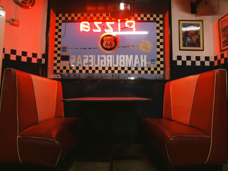Retro American diner with neon signs and red booths