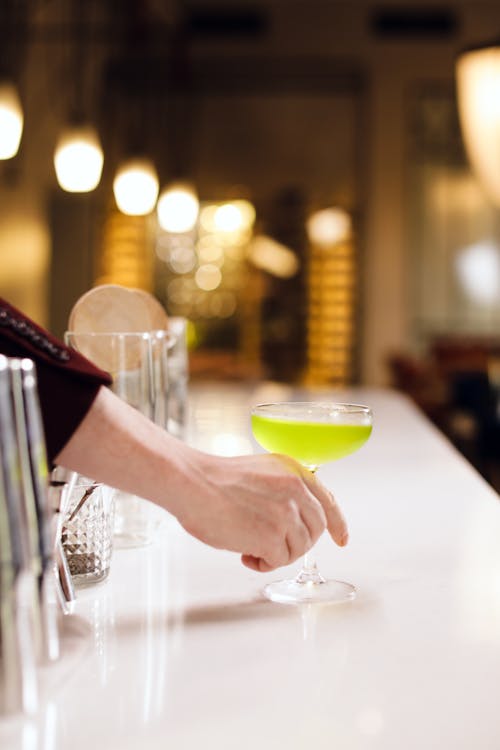 Person Holding a Cocktail Glass