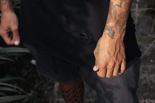 Person in Black Shirt and Shorts with Tattoo