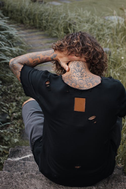 A Back View of a Tattooed Person