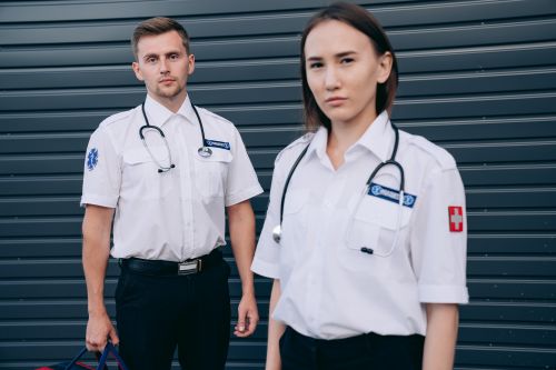 Free Two professional paramedics standing outside, wearing uniforms and stethoscopes. Stock Photo