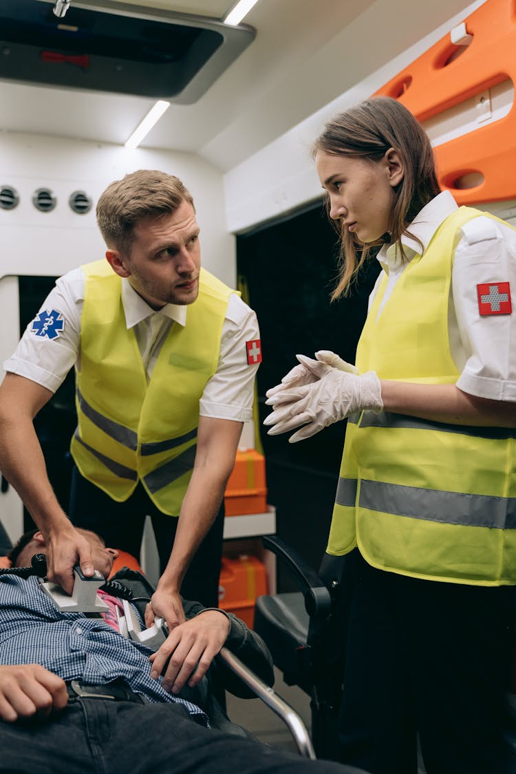 Paramedics Reviving A Patient With Defibrillator