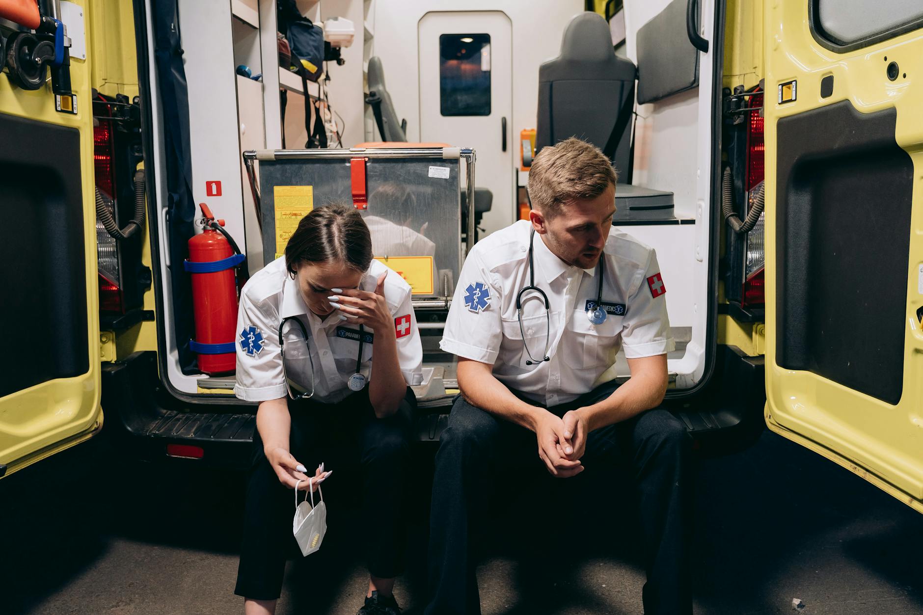 Paramedics Sitting at the Back of an Ambulance