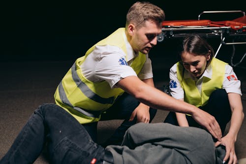 Free Man and Woman Rescuing a Person Stock Photo