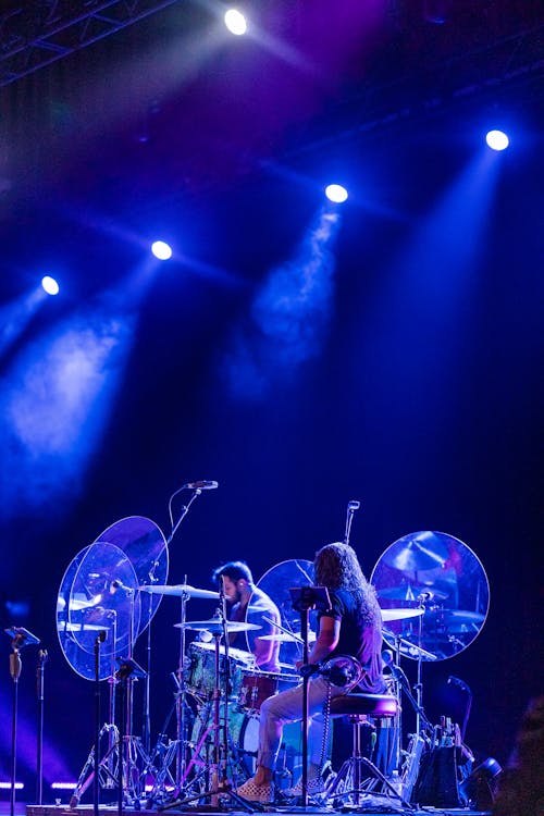 A Band Performance on a Stage with Lights and Smoke