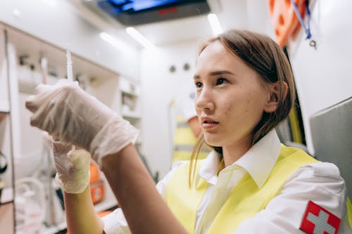 A Paramedic Holding a Syringe