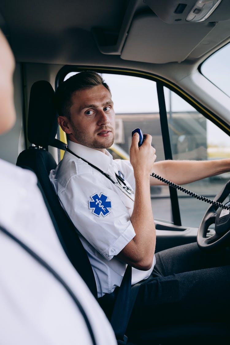 Man In Paramedic Uniform Driving An Ambulance