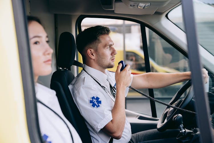 A Paramedic Using A Radio Inside An Ambulance