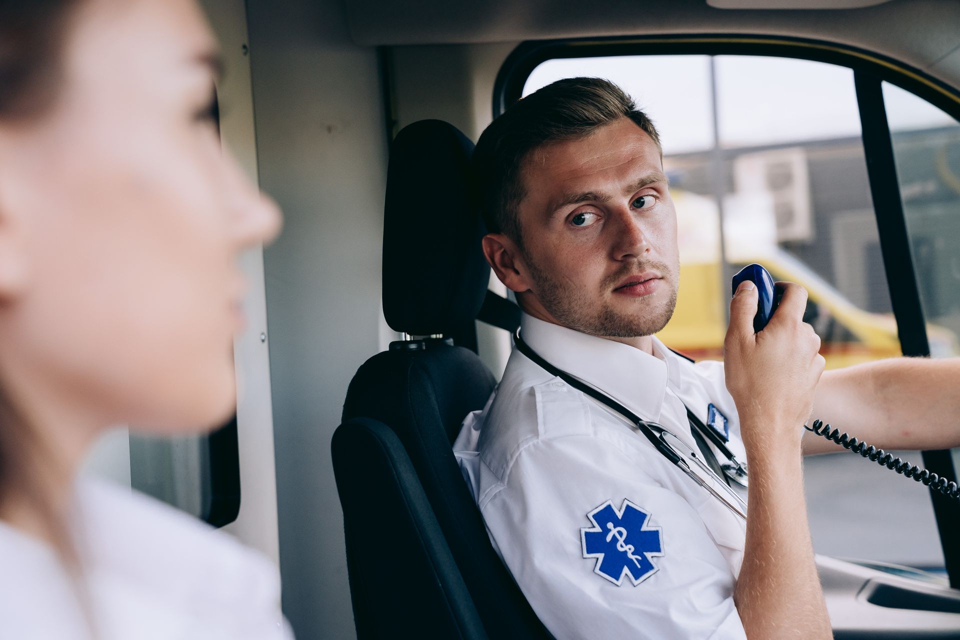 A Paramedic Using a Two Way Radio in an Ambuiance