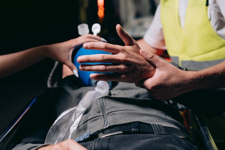 A Paramedic Using A Ambu Bag To A Patient