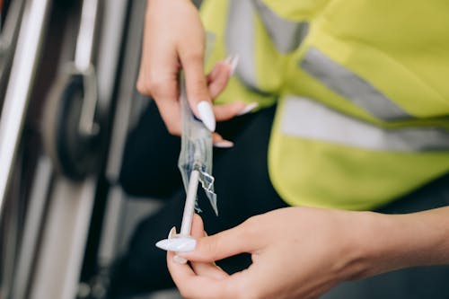 Close-Up Shot of a Person Holding a Syringe