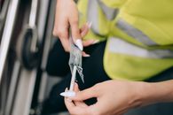 Person Holding White Plastic Clothes Pin
