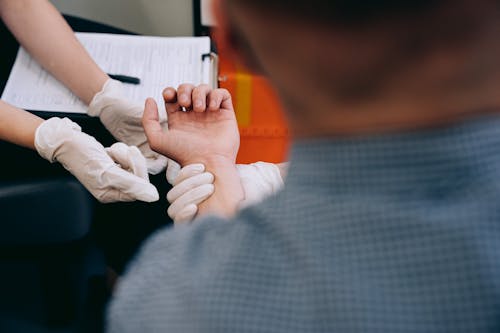 Free Close-up of Paramedics Holding Hand of a Patient  Stock Photo
