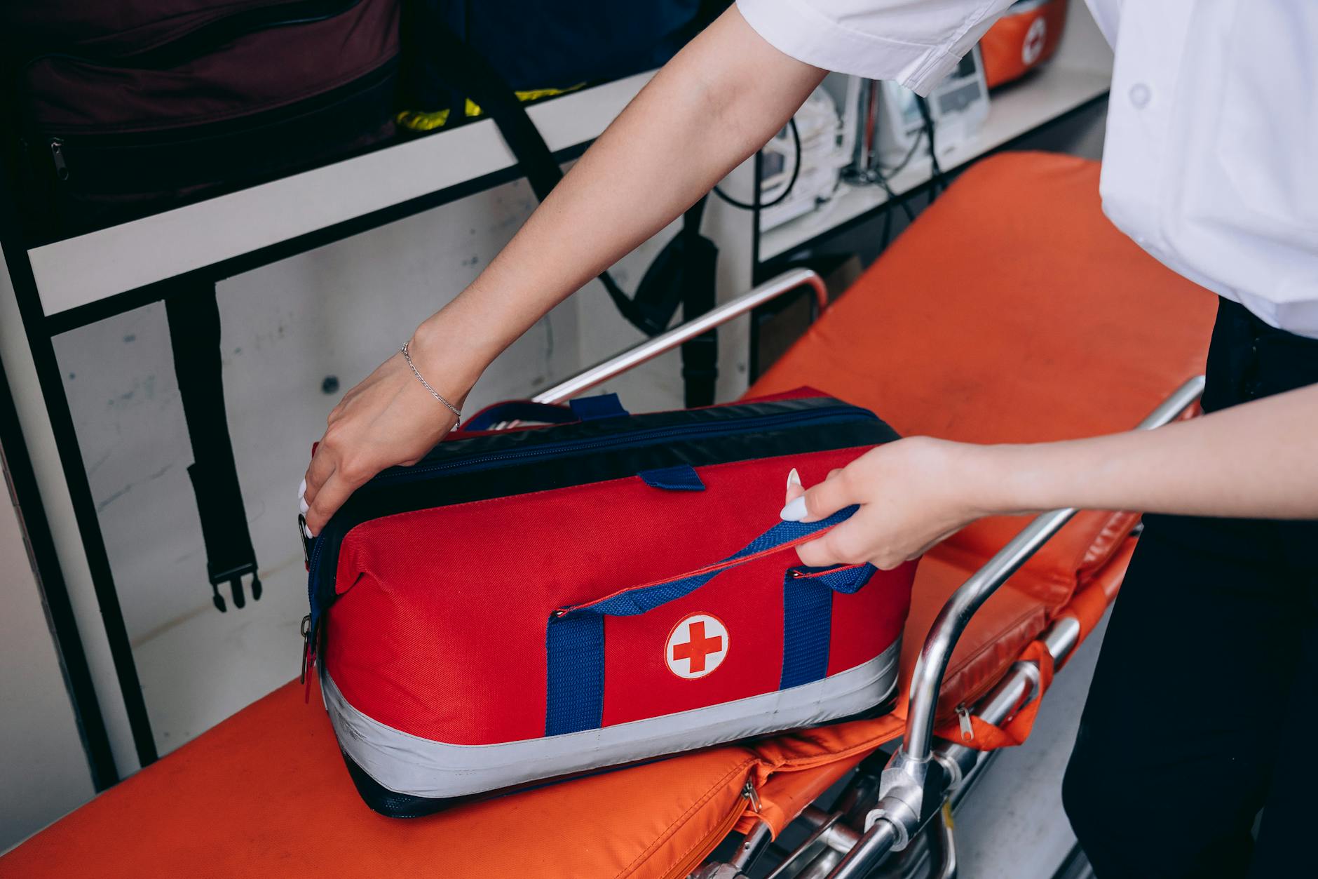 A Person Holding a First Aid Kit on a Stretcher