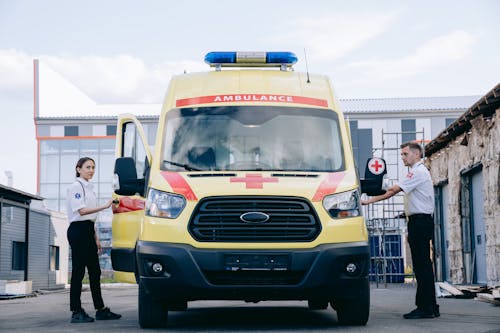 Man and Woman Standing Beside the Ambulance